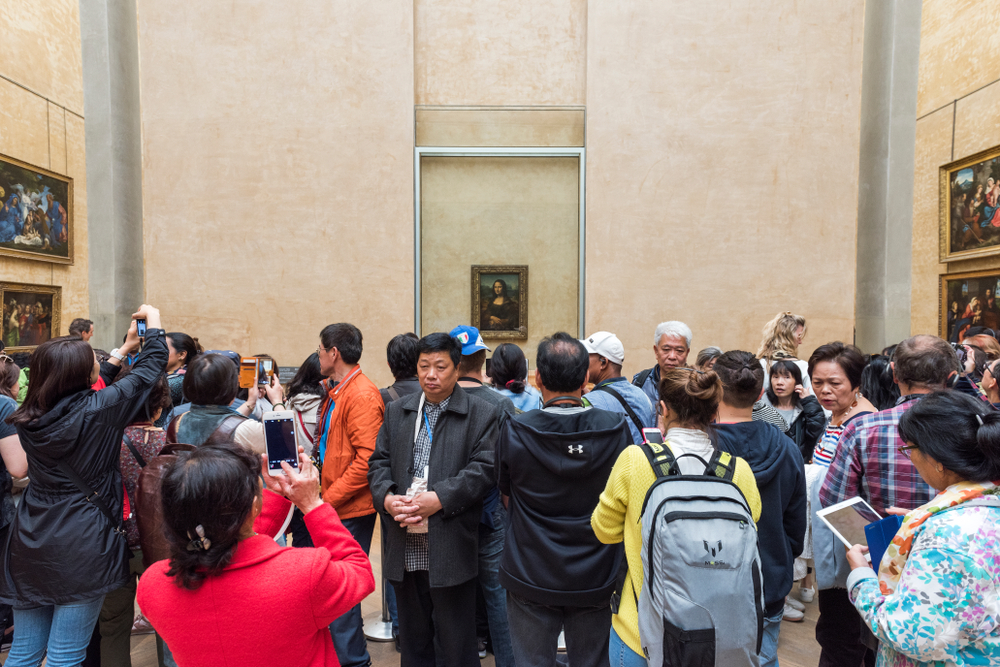 Crowds in front of Leonardo DaVincis Mona Lisa at the Louvre Museum